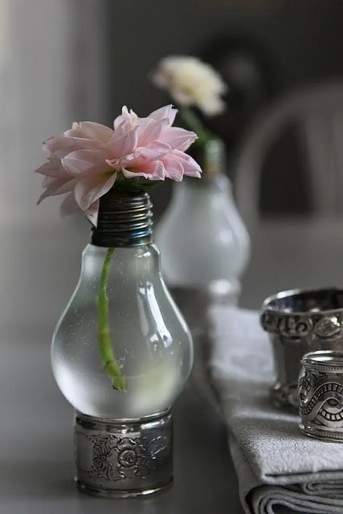 A light bulb vase sitting on a napkin ring