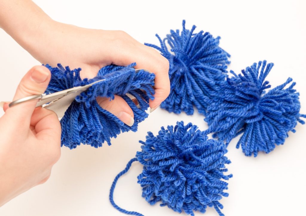 cutting the yarn to form a pompom
