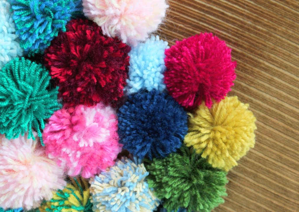 a bunch of pompom for diy pompom rugs