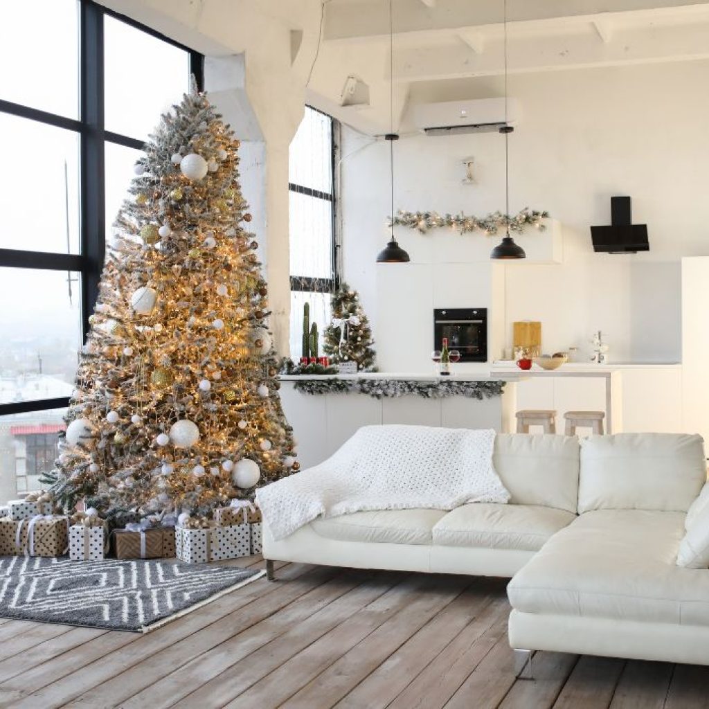 A flocked Christmas tree within a living room.