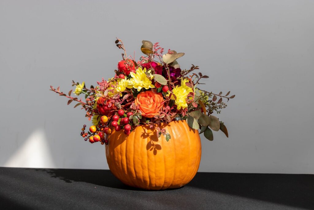 This is a lovely floral pumpkin made of various flowers and plants.