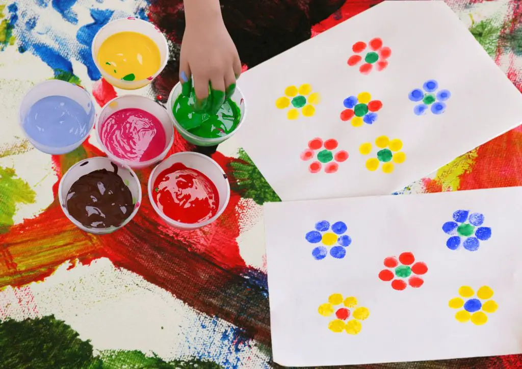 Finger painted flowers are simple and easy.