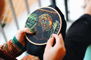 An image of a woman doing embroidery.