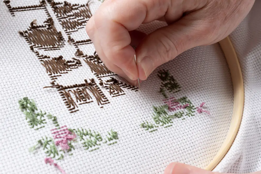 An image of a person creating embroidered texts.