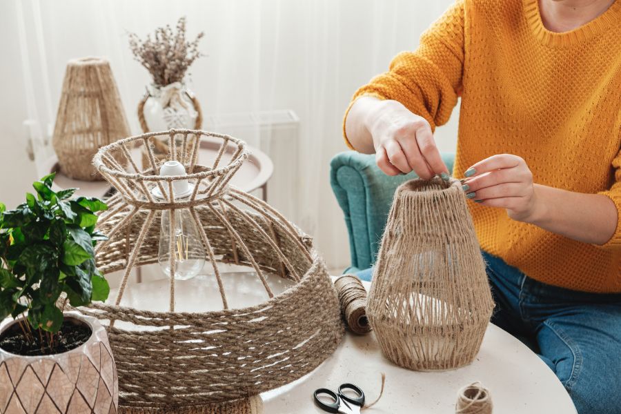 An image of a person crafting their jute basket DIY project.