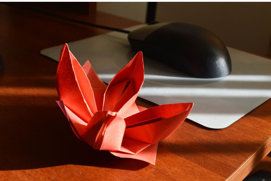 An image of a red origami lily. 