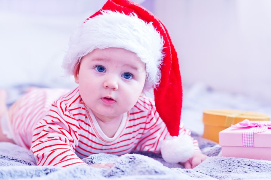 An image of a baby wearing a Santa hat. 